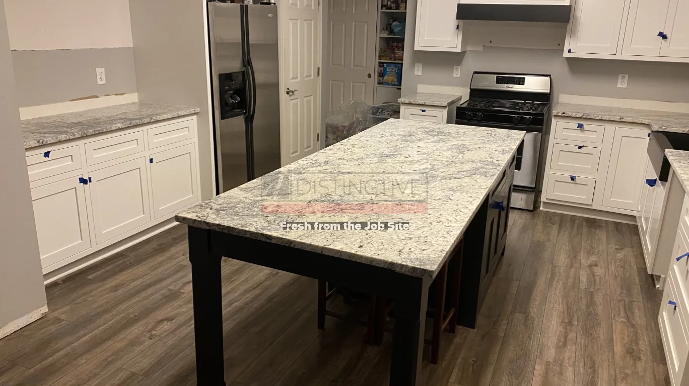 Full White Ice granite slab displayed under showroom lighting
